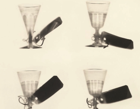 Artwork of four glasses with labels on them by Cornelia Parker
