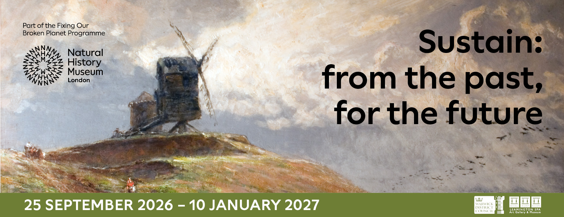 windmill on top of a hill with horse and cart at bottom of hill