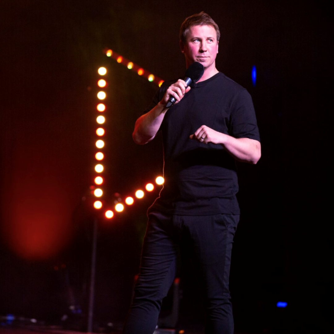 Man in black clothes holding a microphone