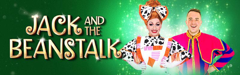 the words 'Jack and the Beanstalk' in Gold writing on a green background with a photo of JP McCue in a dame costume and Sean Dodds in a navy double breasted jacket